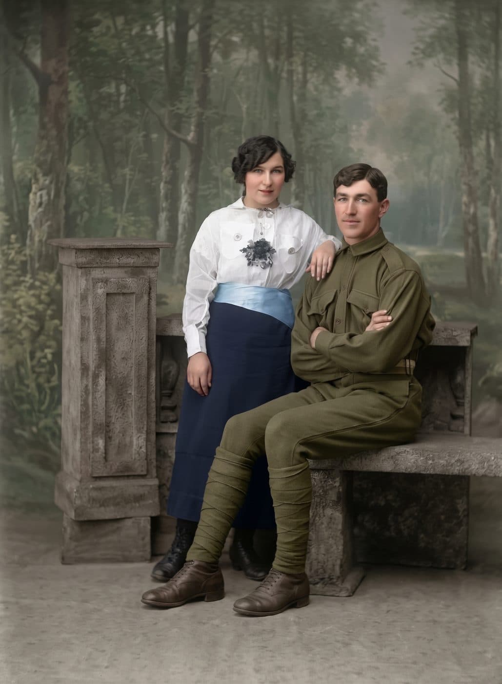 A soldier and a young woman posed by a stone bench, on a plate flaking at the edges, restored and colorized