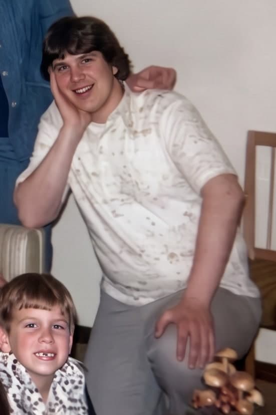 One young man cropped out of a 1970s family group photo, upscaled
