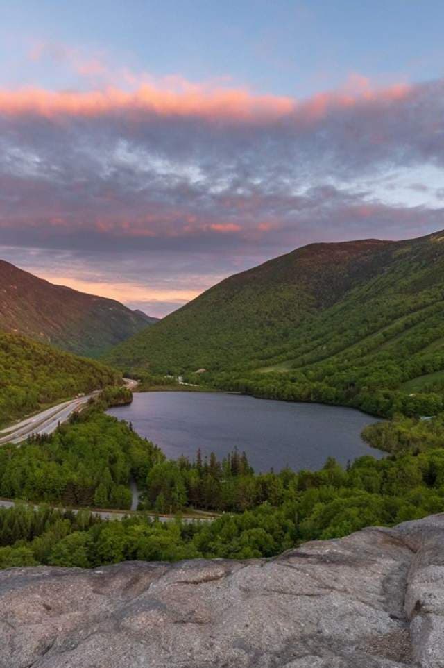 The customer's original: a vertical phone photo of the same lake