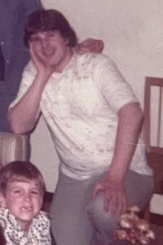 One young man cropped out of a 1970s family group photo, before upscaling